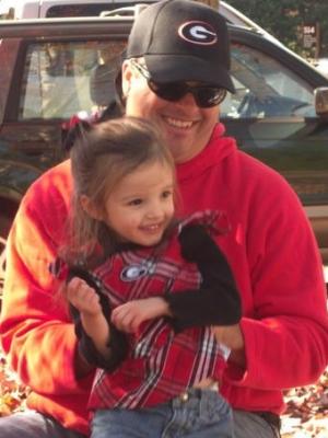 Alana and Preston cheering on the Dawgs.